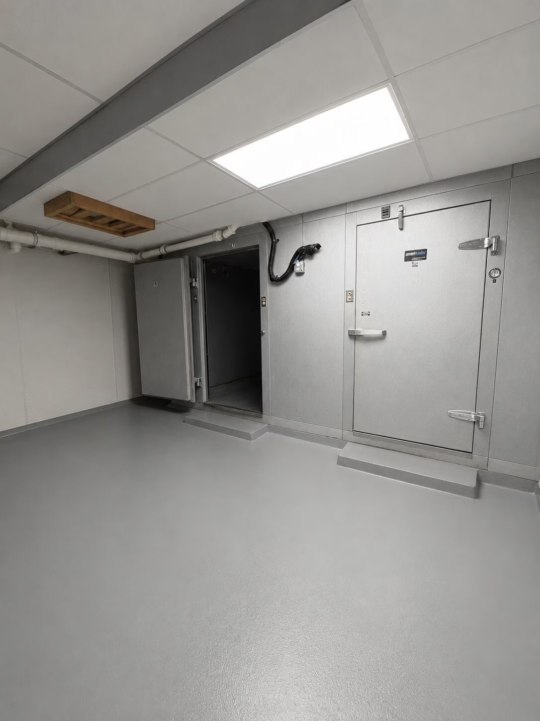 Lower-level prep kitchen with walk-in cooler